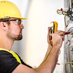 An electrician testing a fuse box.