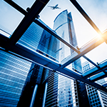 Plane flying over city buildings